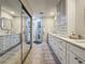 This bathroom features a double sink vanity with a big mirror and tile floors at 2254 Springrain Dr, Clearwater, FL 33763
