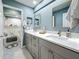 Beautiful bathroom with double sinks, tile floors, and modern design at 2254 Springrain Dr, Clearwater, FL 33763