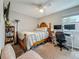Comfortable bedroom featuring a wooden bed frame, ceiling fan, and computer desk at 2254 Springrain Dr, Clearwater, FL 33763