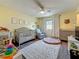 This bedroom features a ceiling fan, nice floors, and window for natural lighting at 2254 Springrain Dr, Clearwater, FL 33763