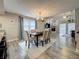 Dining room with modern table and chairs next to the living room and backyard at 2254 Springrain Dr, Clearwater, FL 33763