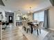 Elegant dining room area with modern chandelier, table set, and open view to entryway at 2254 Springrain Dr, Clearwater, FL 33763