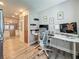 Home office with modern desk setup, decor, and views into the kitchen at 2254 Springrain Dr, Clearwater, FL 33763