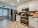 Spacious kitchen with stainless steel appliances and sleek white cabinets, great for cooking at 2254 Springrain Dr, Clearwater, FL 33763