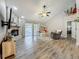 Cozy living room with brick fireplace, ceiling fan, and access to the outdoor space at 2254 Springrain Dr, Clearwater, FL 33763