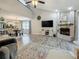 Open-concept living room showcasing a fireplace, tv, and a view into the dining and kitchen areas at 2254 Springrain Dr, Clearwater, FL 33763