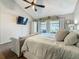 Bright main bedroom offering a ceiling fan and a large bed facing the backyard view at 2254 Springrain Dr, Clearwater, FL 33763