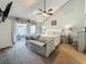 This spacious main bedroom offers a ceiling fan, a sitting area, and a glass sliding door to a private patio at 2254 Springrain Dr, Clearwater, FL 33763