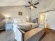This main bedroom offers a sitting area, ensuite, and natural lighting with a ceiling fan at 2254 Springrain Dr, Clearwater, FL 33763