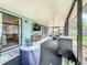 Enclosed patio featuring stylish furniture, large screen television, and sliding glass doors to the home's interior at 2254 Springrain Dr, Clearwater, FL 33763