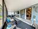 Sunroom with a TV and glass panels with access to both the yard and the home at 2254 Springrain Dr, Clearwater, FL 33763
