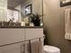 Bathroom vanity with granite countertop and decorative accents at 2500 Winding Creek Blvd # B105, Clearwater, FL 33761