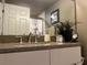 Bathroom vanity features a granite countertop, modern faucet, and stylish decor accents at 2500 Winding Creek Blvd # B105, Clearwater, FL 33761