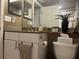 Bathroom vanity with granite countertop and white cabinetry at 2500 Winding Creek Blvd # B105, Clearwater, FL 33761