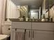 Modern bathroom featuring a granite countertop vanity and decorative accessories at 2500 Winding Creek Blvd # B105, Clearwater, FL 33761