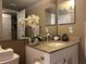 Bathroom vanity with modern fixtures, granite countertop, and modern mirrors at 2500 Winding Creek Blvd # B105, Clearwater, FL 33761