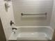 Modern bathtub with white tiled walls and chrome finish fixtures at 2500 Winding Creek Blvd # B105, Clearwater, FL 33761
