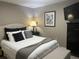 Serene bedroom has pelican artwork, a wall-mounted TV, and a dark dresser to optimize space and decor at 2500 Winding Creek Blvd # B105, Clearwater, FL 33761
