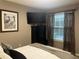Bedroom features a dark wood dresser and a pelican print, complemented by sheer curtains for soft, diffused light at 2500 Winding Creek Blvd # B105, Clearwater, FL 33761