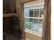 Bedroom featuring an interior courtyard view and a dark wood dresser at 2500 Winding Creek Blvd # B105, Clearwater, FL 33761