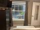 Bedroom featuring an interior courtyard view, dresser, and neutral decor at 2500 Winding Creek Blvd # B105, Clearwater, FL 33761