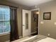Bedroom featuring neutral walls, a window with blinds, and an interesting interior door at 2500 Winding Creek Blvd # B105, Clearwater, FL 33761