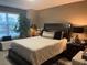 Comfortable bedroom featuring a bed, window, and lamps at 2500 Winding Creek Blvd # B105, Clearwater, FL 33761