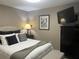 Cozy bedroom with a wall-mounted television and classic pelican artwork, creating a peaceful retreat at 2500 Winding Creek Blvd # B105, Clearwater, FL 33761