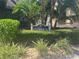 Close-up of the 'Clubhouse' sign, surrounded by lush greenery and manicured bushes at 2500 Winding Creek Blvd # B105, Clearwater, FL 33761