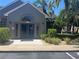 Charming clubhouse exterior with stone accents, well-maintained landscaping, and a welcoming entrance at 2500 Winding Creek Blvd # B105, Clearwater, FL 33761