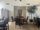 Resident dining area with a round table, chairs, and a tropical palm adding a touch of serenity at 2500 Winding Creek Blvd # B105, Clearwater, FL 33761