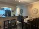Dining area with a view to the breakfast bar, modern kitchen, and comfortable seating for Gathering dinners at 2500 Winding Creek Blvd # B105, Clearwater, FL 33761