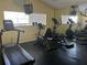 Well-equipped fitness center with a treadmill, elliptical, and mirrored wall for exercise at 2500 Winding Creek Blvd # B105, Clearwater, FL 33761