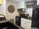 Modern kitchen featuring updated appliances, granite countertops, and stylish decor, enhancing the cooking experience at 2500 Winding Creek Blvd # B105, Clearwater, FL 33761