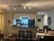 Modern kitchen with black countertops, sleek appliances, a breakfast bar and a view to the dining area at 2500 Winding Creek Blvd # B105, Clearwater, FL 33761