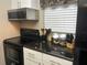 Bright kitchen featuring granite countertops, white cabinetry, and modern appliances at 2500 Winding Creek Blvd # B105, Clearwater, FL 33761