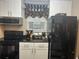Modern kitchen with black appliances, white cabinets, and sleek countertops, providing a functional cooking space at 2500 Winding Creek Blvd # B105, Clearwater, FL 33761