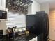 Bright kitchen featuring granite countertops, white cabinetry, and modern appliances at 2500 Winding Creek Blvd # B105, Clearwater, FL 33761