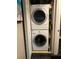 Efficient laundry closet with stacked washer and dryer unit, optimizing space in the home at 2500 Winding Creek Blvd # B105, Clearwater, FL 33761