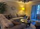 Cozy living room featuring a comfortable sectional sofa and sliding glass doors to the outside patio at 2500 Winding Creek Blvd # B105, Clearwater, FL 33761