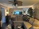 Bright living room with a ceiling fan, open to the breakfast bar and dining area, and large comfy sofa at 2500 Winding Creek Blvd # B105, Clearwater, FL 33761