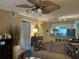 Comfortable living room with a ceiling fan, and a view to the breakfast bar and dining area at 2500 Winding Creek Blvd # B105, Clearwater, FL 33761
