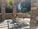 Relaxation patio featuring stone walls, lounging chairs, a pergola, and a peaceful ambiance at 2500 Winding Creek Blvd # B105, Clearwater, FL 33761