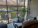 Relaxing screened in patio area with comfortable seating, side table, and views of the outdoors at 2500 Winding Creek Blvd # B105, Clearwater, FL 33761