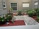 Private patio with decorative plants, gravel, mulch, and garden decor, creating a tranquil outdoor space at 2500 Winding Creek Blvd # B105, Clearwater, FL 33761