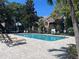 Refreshing community pool surrounded by lush landscaping, lounge chairs, and inviting atmosphere at 2500 Winding Creek Blvd # B105, Clearwater, FL 33761