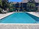 Refreshing community pool with lounge chairs, tables, and chairs for relaxation and enjoyment at 2500 Winding Creek Blvd # B105, Clearwater, FL 33761