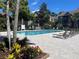 Community pool with lounge chairs and landscaped surroundings in a well maintained area at 2500 Winding Creek Blvd # B105, Clearwater, FL 33761