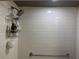 Shower featuring white tiled walls and modern fixtures at 2500 Winding Creek Blvd # B105, Clearwater, FL 33761