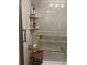 Modern shower with tiled walls, shelving, and grab bars at 2500 Winding Creek Blvd # B105, Clearwater, FL 33761
